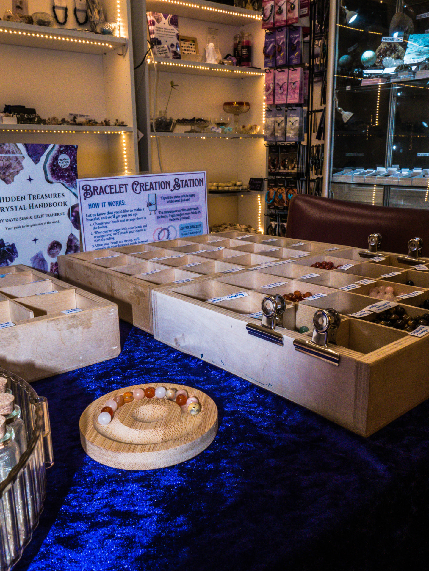 Bracelet Creation Station with wooden bead trays and crystal displays