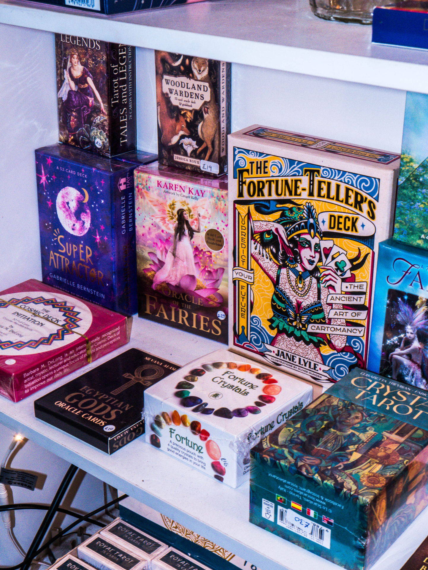 Tarot and oracle card decks displayed on shelves at Hidden Treasures York